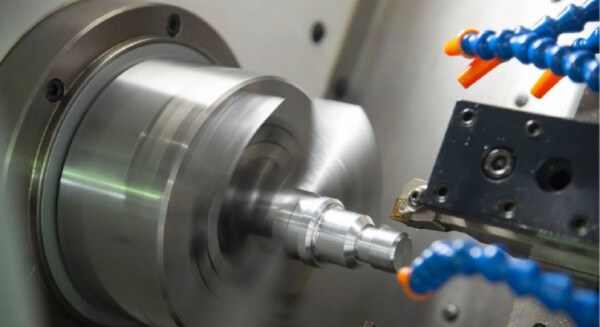CNC turning operation producing a rotational metal part between centres