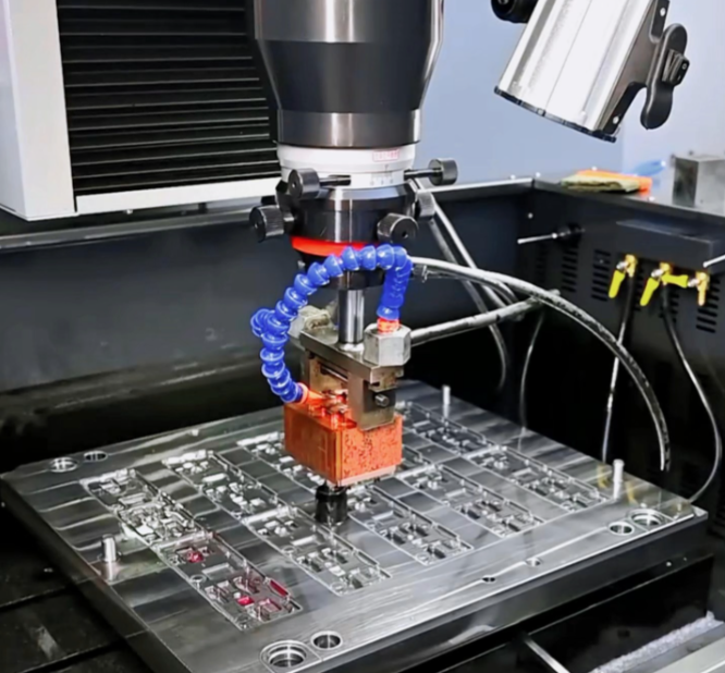 Mirror EDM Process Mirror EDM process on metal part, showing ultra-smooth surface finish, precision electrical discharge machining, and high-accuracy manufacturing.