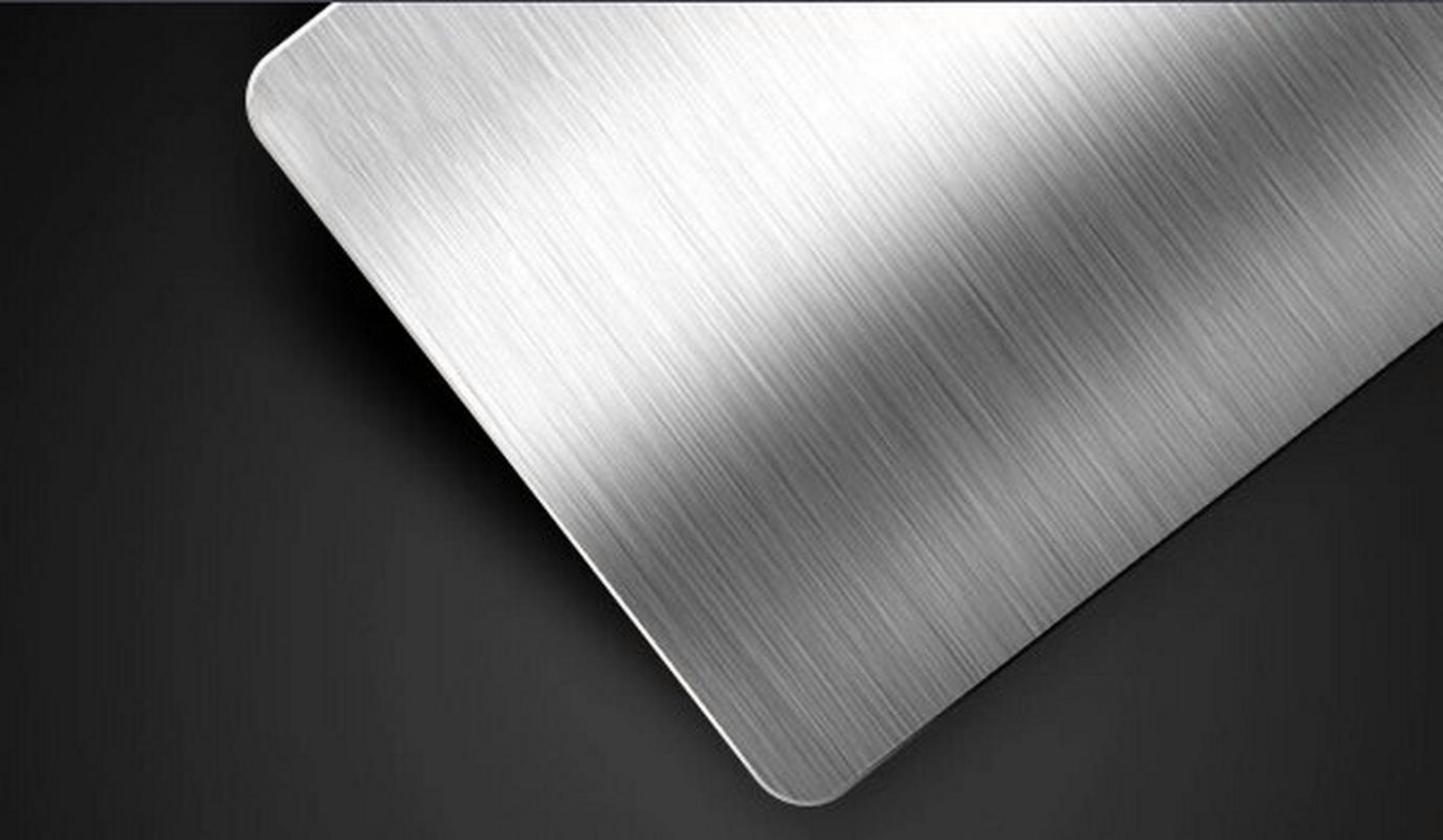 Brushing surface finish on metal parts creating a uniform texture and satin appearance.