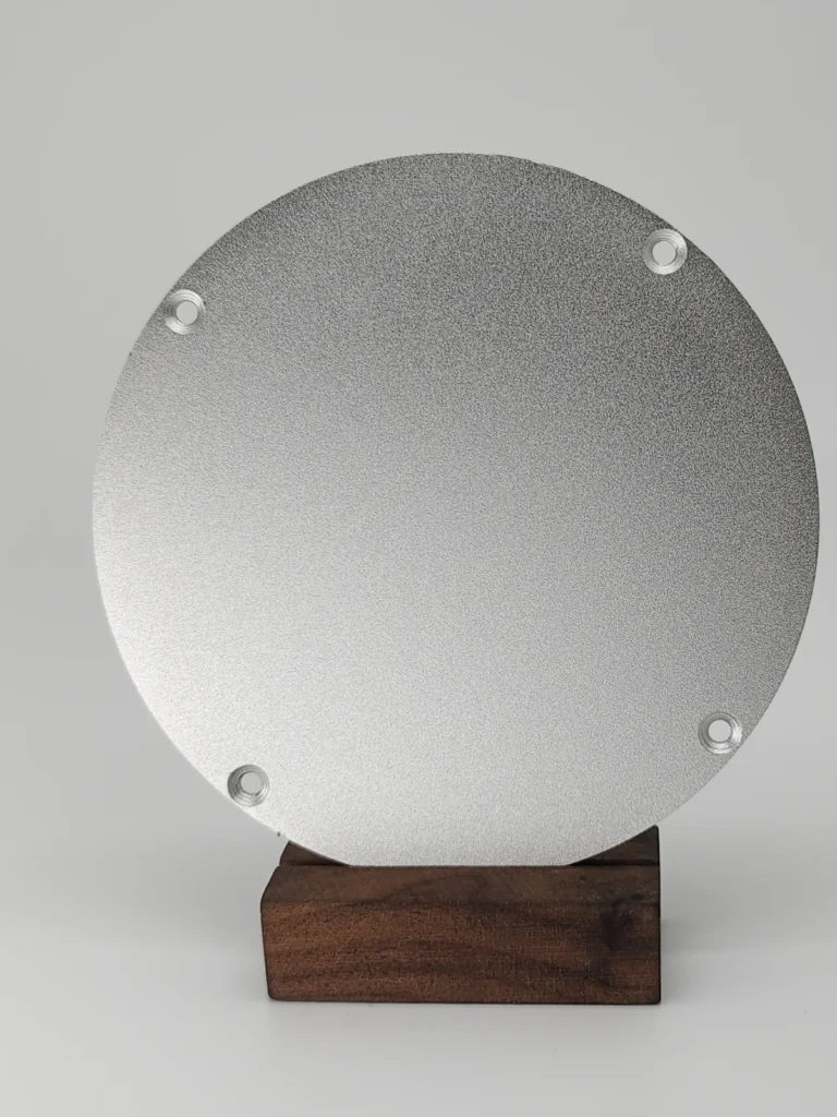 Sandblasting surface finish Sandblasted surface finish on metal part showing uniform matte texture and improved surface adhesion.