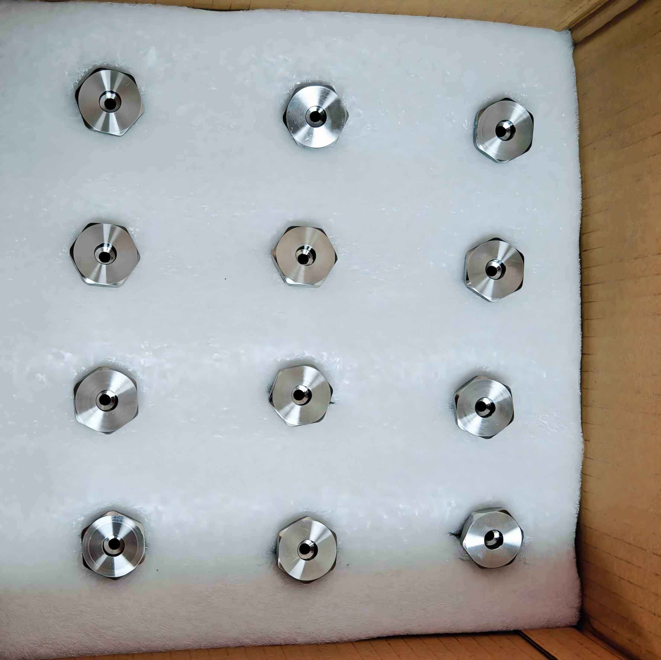 CNC machined stainless steel SS316 components neatly arranged in foam packaging