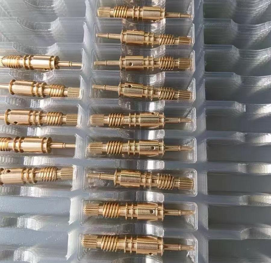 Precision brass CNC machined parts arranged in trays for quality inspection