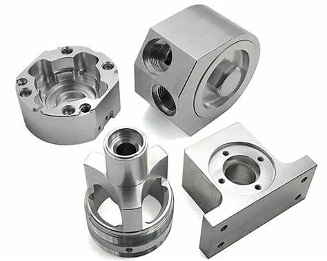 Custom CNC machined metal blocks with threaded ports and precision interfaces