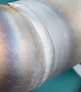 Final continuous weld seam on a pipe joint after tack welding, providing full strength and structural integrity